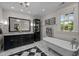 Elegant bathroom with a dual sink vanity, black and white marble floors, and modern fixtures at 1015 Watts St, Durham, NC 27701
