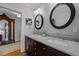 Bathroom featuring double sink vanity, granite countertop, and round mirrors at 1015 Watts St, Durham, NC 27701