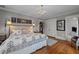 Bedroom featuring hardwood floors, neutral colors, and access to a bathroom and closet at 1015 Watts St, Durham, NC 27701