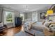 Cozy bedroom with warm hardwood floors, natural lighting, and a neutral color palette at 1015 Watts St, Durham, NC 27701