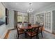 Formal dining room featuring a large wood table, elegant chandelier, and ample natural light at 1015 Watts St, Durham, NC 27701