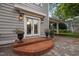 Inviting front entrance with double doors, brick steps, elegant lighting, and beautiful flowerpots enhancing the home's curb appeal at 1015 Watts St, Durham, NC 27701