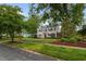 Beautiful two-story house featuring lush landscaping, mature trees, and a welcoming atmosphere at 1015 Watts St, Durham, NC 27701