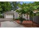 Charming grey home with a two-car garage, well-maintained landscaping, and brick-lined driveway offering excellent curb appeal at 1015 Watts St, Durham, NC 27701