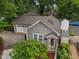 Quaint single-Gathering home with gray siding and a neatly landscaped yard with mature trees at 1015 Watts St, Durham, NC 27701