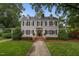 Charming two-story home with a well-manicured lawn and traditional architectural details at 1015 Watts St, Durham, NC 27701