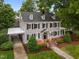 Charming exterior view of a two-story house with a carport and manicured landscaping at 1015 Watts St, Durham, NC 27701