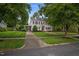 Charming two-story home with mature trees, a well-kept lawn, and a welcoming entrance at 1015 Watts St, Durham, NC 27701