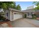 This home has a charming garage with a white door and brick-trimmed driveway at 1015 Watts St, Durham, NC 27701