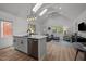 Open kitchen design with a spacious island, stainless steel dishwasher, and an abundance of natural light at 1015 Watts St, Durham, NC 27701