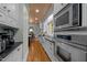 Spacious kitchen with stainless steel appliances, white cabinets, and dark countertops at 1015 Watts St, Durham, NC 27701