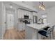 Modern kitchen featuring white cabinets, stainless steel appliances, and a breakfast bar with seating at 1015 Watts St, Durham, NC 27701