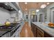 Bright kitchen with white cabinets, granite countertops, stainless steel appliances, and hardwood floors at 1015 Watts St, Durham, NC 27701