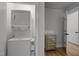Functional laundry closet featuring a washer-dryer combo and a decorative mirrored dresser at 1015 Watts St, Durham, NC 27701