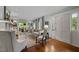 Bright living room with hardwood floors, comfortable seating, and large windows showcasing outdoor views at 1015 Watts St, Durham, NC 27701