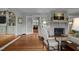 Bright living room with hardwood floors, fireplace, and open doorway to the kitchen at 1015 Watts St, Durham, NC 27701