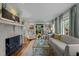 Comfortable living room with a fireplace, large windows, and cozy seating arrangement at 1015 Watts St, Durham, NC 27701