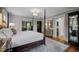 Well-lit main bedroom with access to a dressing room and featuring a four-poster bed at 1015 Watts St, Durham, NC 27701
