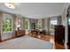 Bright home office with hardwood floors, large rug, and natural light from multiple windows at 1015 Watts St, Durham, NC 27701