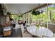 Screened porch with plants, chandelier, and a table with chairs at 1015 Watts St, Durham, NC 27701