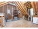 Unfinished attic with wood beams, plywood subfloor, and limited natural light at 105 Houston Cir, Cary, NC 27513