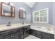 Bathroom with dual sinks, vanity and bathtub with a window view at 105 Houston Cir, Cary, NC 27513