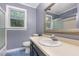 Bathroom featuring blue tiled floors, vanity, toilet, and a shower at 105 Houston Cir, Cary, NC 27513