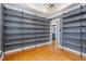 Spacious bedroom featuring gray walls, shelving, hardwood flooring and a modern chandelier at 105 Houston Cir, Cary, NC 27513