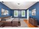 This primary bedroom features sleek contemporary decor and ample natural light from two windows at 105 Houston Cir, Cary, NC 27513
