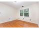 Bedroom with hardwood floors, ceiling fan and bright window view at 105 Houston Cir, Cary, NC 27513