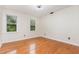 Bedroom with hardwood floors, ceiling fan and bright window view at 105 Houston Cir, Cary, NC 27513