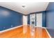 Bedroom with blue walls, hardwood floors and an ensuite bathroom at 105 Houston Cir, Cary, NC 27513