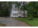 Charming two-story home featuring a well-manicured lawn and a curved driveway at 105 Houston Cir, Cary, NC 27513