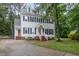 Well-maintained home with black shutters, lush landscaping, and concrete driveway at 105 Houston Cir, Cary, NC 27513