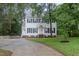 Charming two-story home with symmetrical design, black shutters, and landscaped yard at 105 Houston Cir, Cary, NC 27513