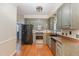 Classic kitchen features painted cabinets, stainless steel appliances, and hardwood floors at 105 Houston Cir, Cary, NC 27513