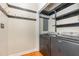 Laundry room with washer, dryer, black shelving and gold hooks at 105 Houston Cir, Cary, NC 27513