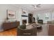 Inviting living room with a whitewashed brick fireplace, ceiling fan, and hardwood floors at 105 Houston Cir, Cary, NC 27513