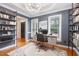 Home office with stylish gray walls, built-in bookshelves, and bright, natural light at 105 Houston Cir, Cary, NC 27513