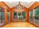 Bright sunroom with wood paneling, hardwood floors, and large windows at 105 Houston Cir, Cary, NC 27513