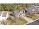 Aerial view of a brick home with a long driveway and mature trees at 105 Stoney Dr, Durham, NC 27703