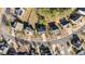 An aerial view of the property and neighborhood showcasing the home's location on a tree-lined street at 105 Stoney Dr, Durham, NC 27703