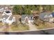 Aerial view of a brick home with a spacious yard and mature trees at 105 Stoney Dr, Durham, NC 27703