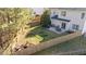 Aerial view of a backyard with a patio, fire pit, and wooden fence at 105 Stoney Dr, Durham, NC 27703