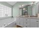 Bathroom features a double sink vanity, granite counters, and a large soaking tub at 105 Stoney Dr, Durham, NC 27703