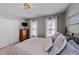 Cozy bedroom with neutral colors and a cushioned bed, showcasing an overhead light fixture and closet at 105 Stoney Dr, Durham, NC 27703