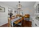 Spacious dining room with modern light fixtures, decorative wainscoting, and hardwood floors at 105 Stoney Dr, Durham, NC 27703