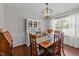 The formal dining room features a decorative light fixture and large windows for natural light at 105 Stoney Dr, Durham, NC 27703