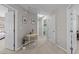 Hallway with multiple doors and a small table with decorations, leading to different rooms in the home at 105 Stoney Dr, Durham, NC 27703