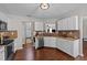 Well-lit kitchen with stainless steel appliances, white cabinetry, and modern finishes at 105 Stoney Dr, Durham, NC 27703